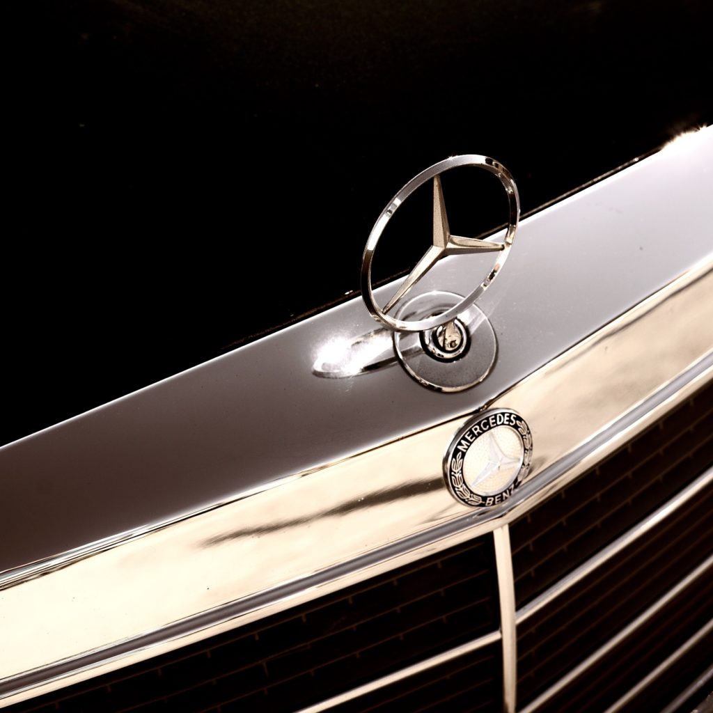 Mercedes logo on hood of car representing a powerful brand